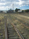 The rail car crosses over the points, and we see the main shed in the distance.