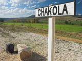 Chakola station sign and surrounding farm land. My backpack can be seen at the bottom.