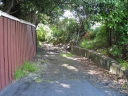 A side alley next to the Woburn road bridge, next to Leighton Avenue. The path leads to a dead end.