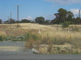 A look at the gate and railway poles southeast of the crossing. The hump is where the platform sits.