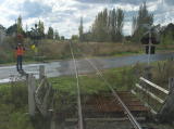 The crossing lights are working, and a volunteer makes sure traffic is stopped before the rail car proceeds.