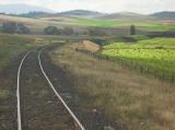 Block-of-line boards can be seen on the track. In the far distance, the bridge can be seen.