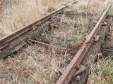 Small flood opening, along with misaligned plates at 227km on the Crookwell line. Spots of rain can be seen on the rail.