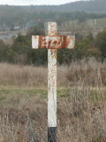 The 227km post on the Crookwell line. Rain can be seen in the background.