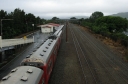 Looking north from the southern foot bridge of Woburn station. A unit is pulling out of the station.