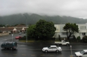 Looking east from the southern footbridge. In the foreground is Cambridge Terrace and Hawkins Street. The Wainui hills in the background are shrouded in mist.