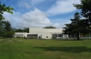 A view from a park bench next to Queens Drive, Lower Hutt. The building shown is the Little Theatre.