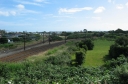 A view of the railway junction south of Woburn station. To the left is the branch line towards to Woburn railway workshops. To the right is the main Hutt Valley line. On the far right is a paddock where horses once grazed.