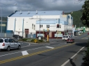 An eastward shot from the road bridge looking towards the disused building complex. The layout and style of the building suggests it may have once been a suburban movie theatre.