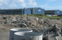 A longer shot of the two near buildings of the railway workshop. The logo 'Alstom' can be easily seen on the side of both buildings.