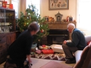 Mum and Dad about to open Christmas presents.