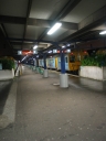 Platforms five and six of Wellington Railway Station. Some rain is visible on the ground.