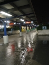 Platforms three and four of Wellington Railway Station. The puddles in the foreground show the rain.