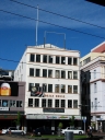 Trojan House on Manners Street, Wellington. I lived on the second floor (where the windows appear to be boarded up) for around six months. In the foreground is Te Aro Park, formerly Pidgeon Park.