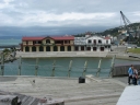 The boatshed and Rowing club from the same footbridge. In the foreground is the lagoon, and begind it towards the left is Wellington Harbour.