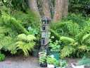 A tower nestles in amongst ferns in my parents' back yard, Lower Hutt.