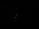 Fireworks rise above Peka Peka beach at midnight on New Years. The shot looks south along the beach towards Paraparaumu beach.