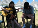 Snaiet and Haydn look down at the song book while singing harmonies outside the Sand Castle Motel.