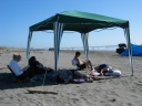 Jann, Snaiet, Haydn, Mauricio, and Denise at Peka Peka beach. On the far right a family have put up a makeshift tent next to their car.