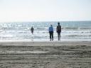Snaiet, Jann, and Mauricio try the water at Peka Peka beach.