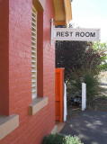 'Rest Room' sign on the eastern side of the building. On the far right, the tracks heading north can be seen.