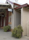 A look south from the northern end of Cooma station platform focussing on the  'Gentlemen' and 'Ladies Room' signs.