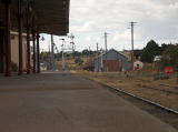 A view at ground level along the station platform looking north to the yard and signals.