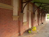 Looking down the platform at boarded-up doors and windows of Binalong station.