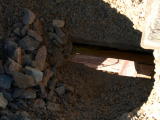 A view through a decking hole on Guises Creek bridge.