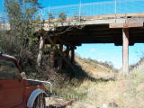 The Kelly Road bridge, with fallen trees and the remains of a TV set.