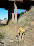 The remains of a television, dumped from the Kelly Road overbridge, are retrieved from the railway corridor.