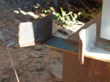 The bracket at the bottom of the carriage shed, holding the door in place, shows signs of wear.