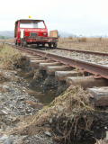 Scouring of the track base and remaining flood water, on the down side of the railway line, near 343.4km.