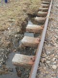 Exposed sleepers and remaining flood water, near 343.4km.
