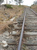 Filled flood opening near 342km, with exposed sleepers.
