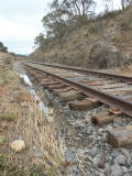 Exposed sleepers and remaining flood water, near 341.9km.