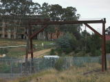 The goods crane at Queanbeyan rail yard. The crane now straddles a security fence.