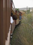 The train pauses in the cutting just outside of Queanbeyan station.