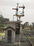 The signals at Queanbeyan station point up as diesel 7319 crosses back to the main line.