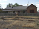 The stationmaster's house with a gate into the yard. The house is currently for sale according to one of the locals.